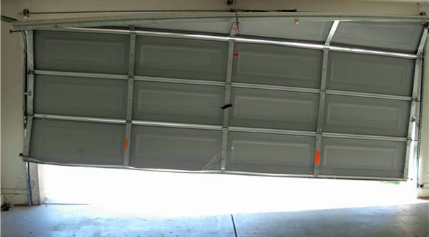 Garage Door Services Houston TX a large garage door that fell off the tracks