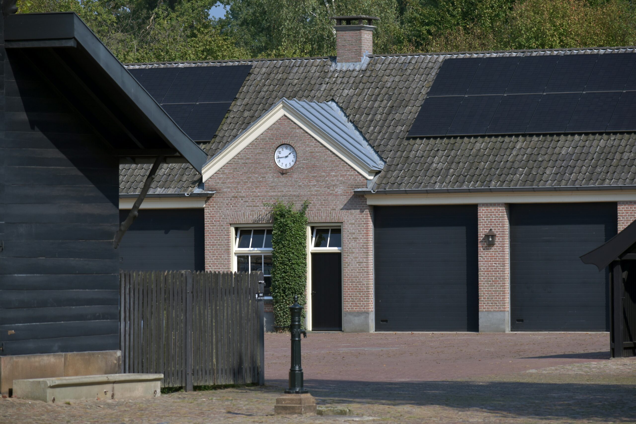 Garage Door Services Houston TX a grey house with 3 black black doors