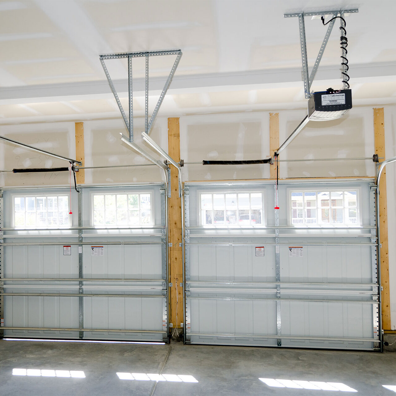 Broken Spring Replacement Houston TX 2 regular sized garage doors, inside of the garage perspective